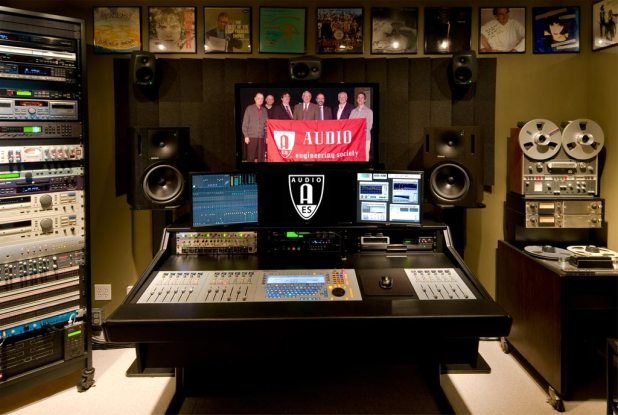 Recording studio with pictures of AES on the TV monitors in the middle